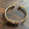 Adjustable bracelet with golden charms