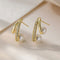 Elegant pointed earrings with pearl and zirconia in gold